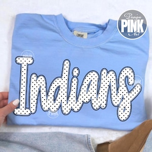May include: A light blue sweatshirt with the word "Indians" in a black and white polka dot design. The sweatshirt has a crew neck and long sleeves. The text is in a playful, bubble-style font.