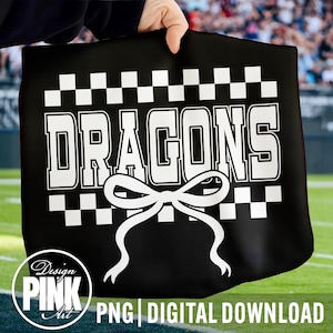 May include: Black tote bag with the word "DRAGONS" in large white block letters, a white bow graphic, and a checkered border. The bag also features the text "PNG DIGITAL DOWNLOAD" and a "Design Pink Art" logo.