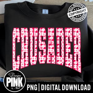 May include: Black sweatshirt with the word "CRUSADER" in large, pink letters filled with a pattern of small pink hearts. The design includes a "Design Pink Art" logo and the text "PNG | DIGITAL DOWNLOAD".