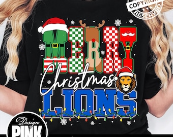 May include: Black t-shirt with a festive Christmas design. The words "MERRY CHRISTMAS LIONS" are displayed in a playful font, with each letter decorated with holiday-themed elements. A lion wearing a Santa hat is featured.
