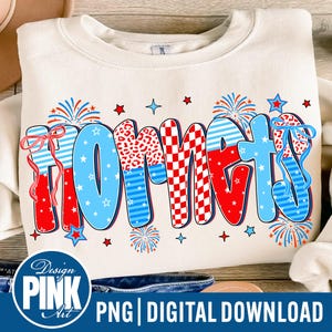 May include: Cream-colored sweatshirt with the word "HORNETS" in a colorful, patriotic design. The letters feature red, white, and blue patterns, including stripes, checks, and animal print, with star and firework accents.