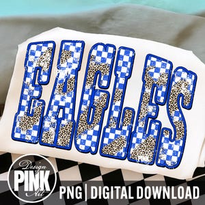 May include: White t-shirt with the word "EAGLES" in large, bold letters. The letters have a blue and white checkered pattern with a leopard print fill. The design includes the text "PNG | DIGITAL DOWNLOAD" and a logo.