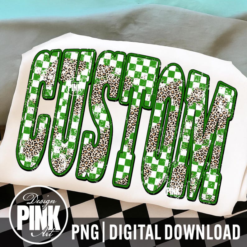 May include: White t-shirt with the word "CUSTOM" in large, bold letters. The letters have a green and white checkered pattern, with leopard print accents. The design includes the text "Design PINK Art" and "PNG | DIGITAL DOWNLOAD".
