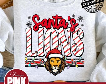 May include: A light gray sweatshirt with the text "Santa's Lions" in red and white striped letters. A lion wearing a Santa hat is below the text, with a string of colorful lights. The words "Design Pink Art" and "PNG | DIGITAL DOWNLOAD" are also visible.