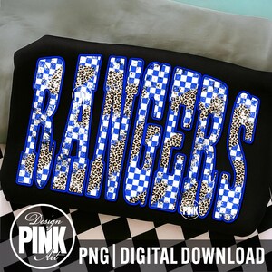 May include: Black graphic t-shirt with the word "RANGERS" in large, bold letters. The letters feature a blue and white checkered pattern and leopard print. The design includes the text "PNG | DIGITAL DOWNLOAD" and a "Design PINK Art" logo.