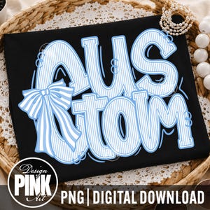 May include: Black t-shirt with the word "CUSTOM" in light blue, outlined in white. The word has a striped pattern and a bow on the left side. The bottom of the shirt has the text "PNG | DIGITAL DOWNLOAD".