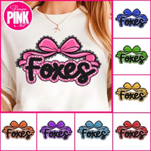 May include: White sweatshirt with a pink bow and the word "Foxes" in a black and pink leopard print design. Additional designs with bows in blue, green, yellow, orange, purple, and red are also shown.