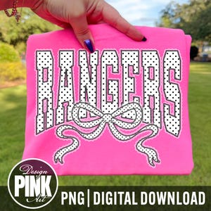 May include: A bright pink t-shirt with the word "RANGERS" in a white polka dot font, outlined with a lace design. A white bow with lace trim is centered below the word. The bottom of the shirt has the text "PNG | DIGITAL DOWNLOAD".