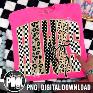 May include: A bright pink sweatshirt with the word "HAWKS" in a bold, decorative font. The letters feature a mix of patterns, including checkered, leopard print, and polka dots, outlined in gold. A black bow is centered on the letters. The bottom of the image reads "PNG | DIGITAL DOWNLOAD".
