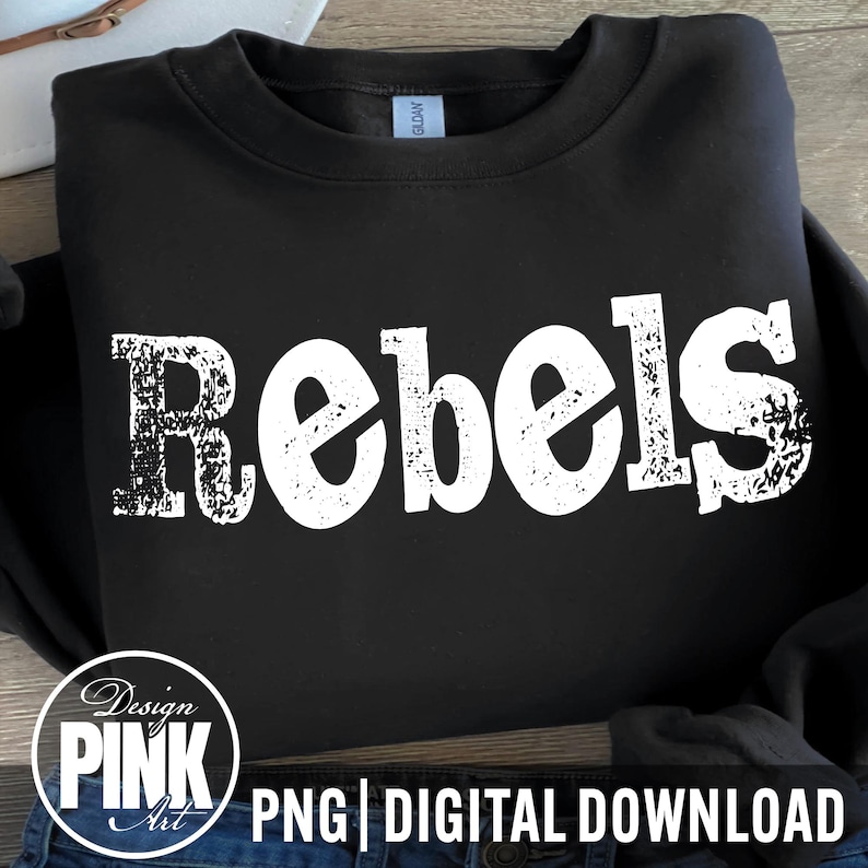 May include: Black sweatshirt with the word "Rebels" in distressed white lettering across the front. The design includes a circular logo that says "Design Pink Art" and the words "PNG | DIGITAL DOWNLOAD".