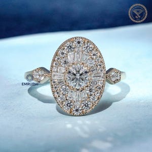 May include: A gold ring with a large oval-shaped centerpiece, encrusted with numerous small, sparkling diamonds. The center features a prominent round diamond surrounded by baguette-cut diamonds, creating a dazzling effect. The ring has smaller diamond accents on the sides.