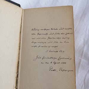 May include: Open book with handwritten text in German. The text is in black ink on aged, cream-colored paper. The book's spine is visible, showing the binding. The text includes a date of April 6, 1888.