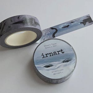 May include: Gray washi tape with a landscape design featuring a snake and birds. The tape roll has the text "irnart" and "Washi Tape 15mm x 10m". The tape is unrolled to show the design.