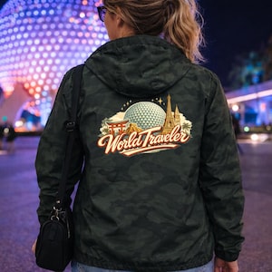 May include: A white ceramic mug with a black handle and the text "But First, Coffee" in a black, handwritten-style font. The mug is on a white surface.