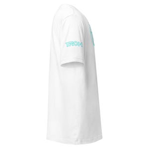 May include: A white t-shirt with the word "TRON" printed in a light blue color on the left sleeve. The shirt has a crew neck and short sleeves. The overall design is simple and clean.