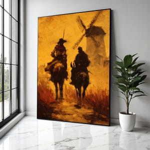 Puede incluir: Una pintura al óleo representa dos figuras a caballo, silueteadas contra un cielo amarillo dorado. Un molino de viento es visible en el fondo. La obra está enmarcada en negro y se apoya en una pared blanca.