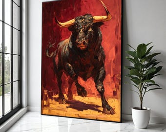 May include: A framed painting of a charging bull. The artwork features a dark bull with golden horns against a red and yellow background. The painting is displayed in a bright room with a window and a potted plant.