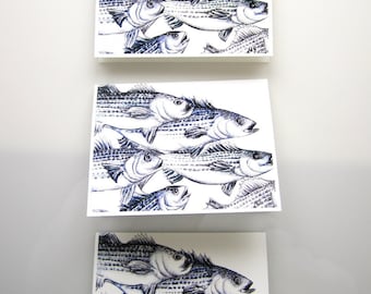 May include: Three square art prints with detailed pen and ink illustrations of fish. The fish are depicted in a stylized manner, with dark blue lines and shading on a white background. The prints are arranged vertically.