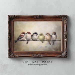 May include: An art print in a dark brown ornate frame, depicting six small birds on a wire. The birds have brown, black, and yellow feathers. The text "VIN ART PRINT" and "Subtle Vintage Stories" are at the bottom of the print.