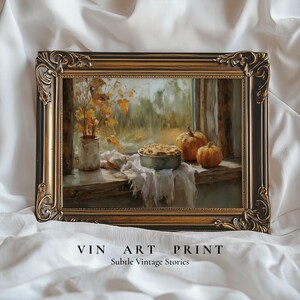 May include: A rectangular wall art print in an ornate, dark brown and gold frame. The painting depicts a still life scene on a windowsill with a pie in a metal pan, two orange pumpkins, and a vase of yellow autumn leaves. Text reads VIN ART PRINT.