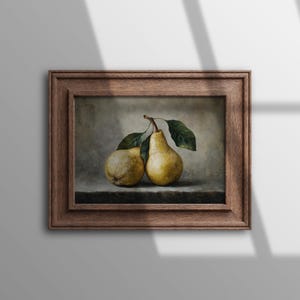 May include: A framed oil painting depicting two yellow pears with green leaves on a dark surface against a neutral background. The artwork is enclosed in a thick, textured brown wooden frame with a stepped, multi-layered profile design.