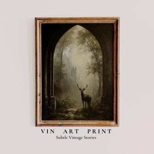 May include: A framed vintage art print depicting a deer in a misty forest, seen through an arched doorway. The artwork has a muted colour palette with the text "VIN ART PRINT" and "Subtle Vintage Stories" at the bottom.