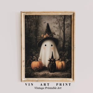 May include: A framed vintage print featuring a friendly ghost wearing a witch hat, flanked by two orange pumpkins and a black cat in a witch hat. The artwork is set against a backdrop of a dark forest. The text "VIN ART PRINT Vintage Printable Art" is at the bottom.