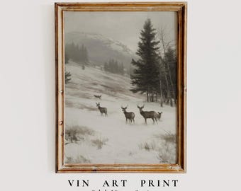 May include: Vintage art print in a wooden frame. The artwork depicts a winter landscape with deer in a snowy field, with trees and a mountain in the background. The text at the bottom reads "VIN ART PRINT" and "Subtle Vintage Stories."