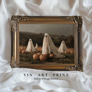 May include: A rectangular wall art print in an ornate dark brown and gold frame. The artwork depicts four figures draped in white sheets resembling ghosts standing in a pumpkin patch with orange pumpkins and a dark, cloudy landscape in the background.