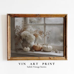 May include: A framed vintage art print featuring a still life with pumpkins and flowers on a windowsill. The print has a warm color palette with the text "VIN ART PRINT" and "Subtle Vintage Stories".