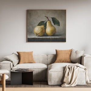 May include: A framed wall art print featuring a still life painting of two yellow pears with green leaves resting on a dark stone surface against a muted gray background. The pears are rendered with realistic textures and soft lighting.