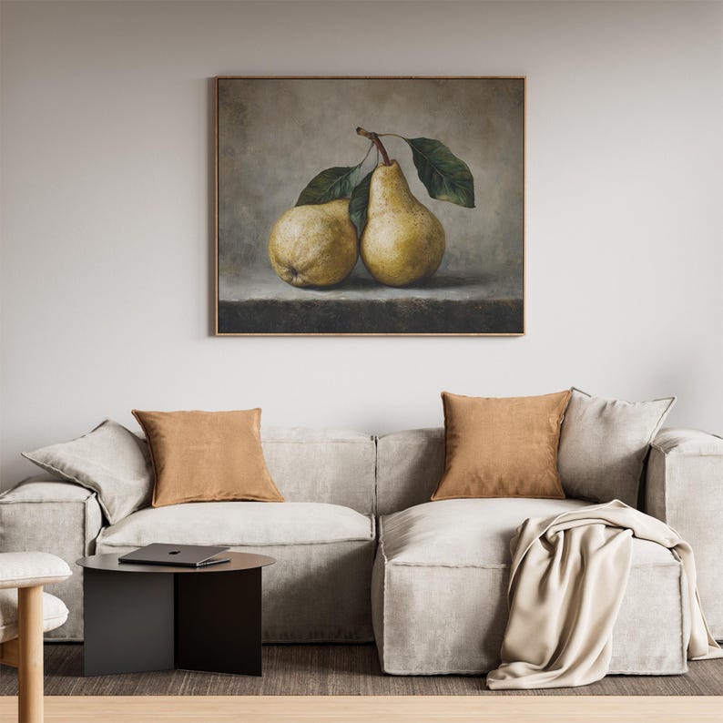 May include: A framed wall art print featuring a still life painting of two yellow pears with green leaves resting on a dark stone surface against a muted gray background. The pears are rendered with realistic textures and soft lighting.