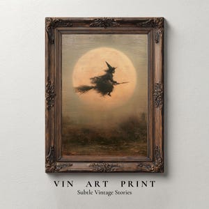 May include: A framed wall art print featuring a silhouette of a witch flying on a broomstick against a large, pale full moon. The artwork is enclosed in a dark, ornate, carved wooden frame. Below the frame, the text reads VIN ART PRINT Subtle Vintage Stories.