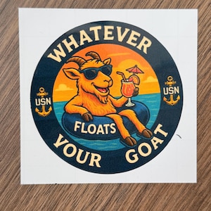 May include: A circular sticker featuring a cartoon goat wearing sunglasses and floating on an inner tube in the ocean. The sticker reads "Whatever Floats Your Goat" and includes the letters "USN" with anchors.