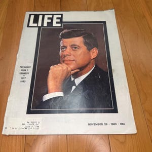 May include: A vintage LIFE magazine cover from November 29, 1963, featuring a portrait of President John F. Kennedy with his hand near his chin. The text reads President John F. Kennedy 1917-1963, LIFE, November 29, 1963, and a price of 25 cents.