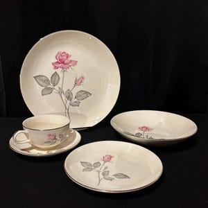 May include: A set of three ceramic mugs with a speckled, matte finish in cream, light grey, and dark grey. Each mug has a simple, minimalist design, ideal for coffee or tea.