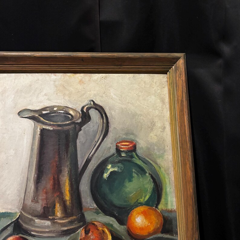 May include: Oil painting of a still life with a silver pitcher, a green bottle with a red cap, and several oranges. The painting is in a wooden frame.