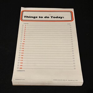 May include: A notepad with the text "Things to do Today" in a red and black rectangular border. The notepad has numbered lines with checkboxes for planning and completion, and a space for comments. The notepad is white with black text.