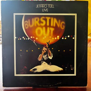 May include: Album cover for Jethro Tull's "Bursting Out Live." The cover features a live performance image with a singer on stage, arms raised, and the album title in large, illuminated letters against a dark background. The band's name is at the top.