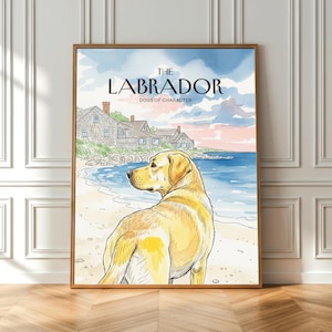 Op de afbeelding: Een ingelijste aquarelprint met een gele Labrador Retriever op een strand, met de tekst "THE LABRADOR DOGS OF CHARACTER". De achtergrond toont een kustlandschap met huizen en een blauwe en roze lucht. Het kunstwerk zit in een houten lijst.