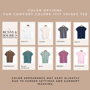 May include: A display of Comfort Colors 1717 unisex tees in various colors, including white, ivory, pepper, navy, espresso, blue spruce, bay, berry, and blossom. The text "COLOR OPTIONS" and "BUNNY & BOURBON" are also visible.