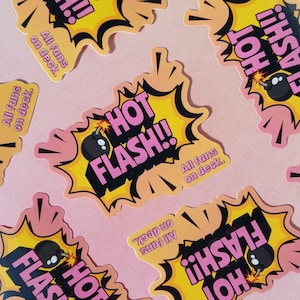 May include: A collection of stickers with a comic book style design. Each sticker features the words "HOT FLASH!!" in pink, a black bomb, and the phrase "All fans on deck." The stickers are on a pink background.