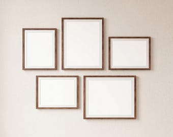 May include: A gallery wall mockup showing five framed art prints with white mounts and dark brown wooden frames. The frames are arranged in a cluster on a light beige wall. The text "GALLERY WALL MOCKUP" and "PSD • JPG" are visible.