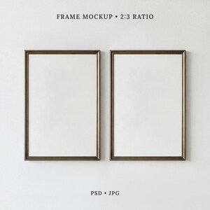 May include: Two vertical rectangular frames with dark brown borders and white matting, displayed side by side. The text at the top reads FRAME MOCKUP 2:3 RATIO, and the text at the bottom reads PSD JPG. The frames are empty and feature a clean design.