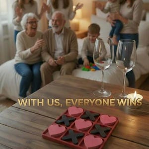 May include: A wooden table features a red tic-tac-toe game with pink heart and black X pieces. Two wine glasses and a lit candle are on the table. The text "WITH US, EVERYONE WINS" is displayed. A family is in the background.