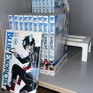 May include: A collection of "Blue Exorcist" manga volumes. The first volume features a character illustration with the title and author's name. The spines display the series title in blue and white. The set includes volumes 1 through 10 and volume 16.