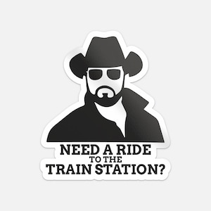 Op de afbeelding: Zwart-witte sticker met een silhouet van een man met een cowboyhoed en zonnebril. De tekst op de sticker luidt: "NEED A RIDE TO THE TRAIN STATION?"