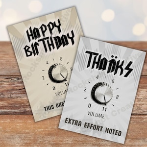 May include: Two greeting cards with a musical theme. One card says "Happy Birthday" and the other says "Thanks". Each card features a volume knob graphic with the word "Volume" and the number "11". The bottom of the "Thanks" card says "Extra Effort Noted".