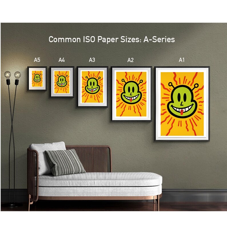May include: A display of framed art prints in various sizes, including A1, A2, A3, A4, and A5, featuring a smiling alien face with a yellow background and red rays. The text "Common ISO Paper Sizes: A-Series" is visible.