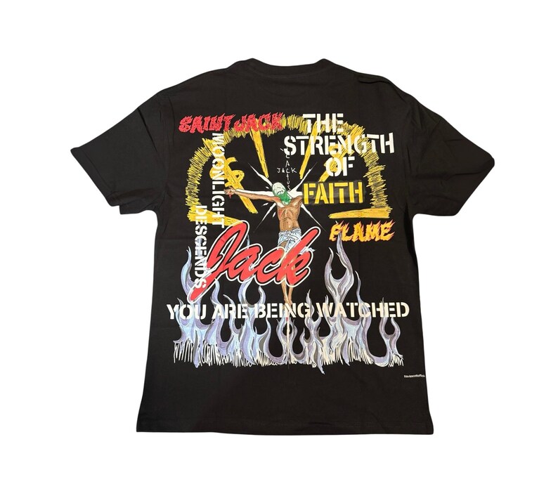 May include: Black t-shirt with a graphic design featuring a figure with outstretched arms, a green mask, and the word "Jack" in red. The design includes flames, text, and a yellow halo.